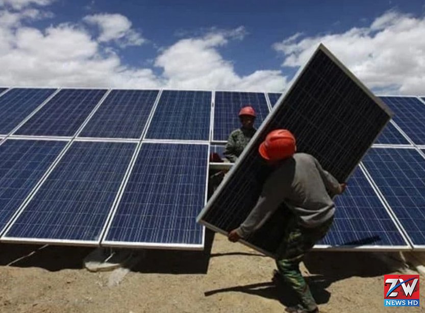 Workers install solar panels at a renewable energy site as green energy companies call for lower taxes to support clean energy growth.