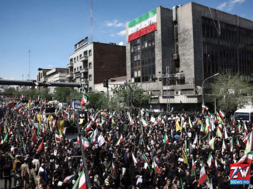 A tense geopolitical scene featuring the flags of Iran and the United States facing each other, symbolizing rising tensions after Iran warned that any future US attacks would receive a much stronger response.