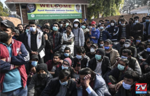 Students in Peshawar protesting on the streets against increased educational fees, holding placards and chanting slogans.