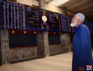 Investors monitor stock market screens as the Pakistan Stock Exchange (PSX) drops 375 points amid increased selling pressure.