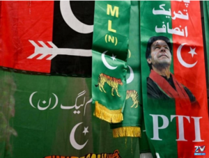 Supporters and election officials gather at a polling station as two major political parties raise concerns over alleged violations of election rules during the voting process.