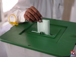 Voters line up at a polling station in Azad Kashmir as the first phase of local elections begins under security arrangements.